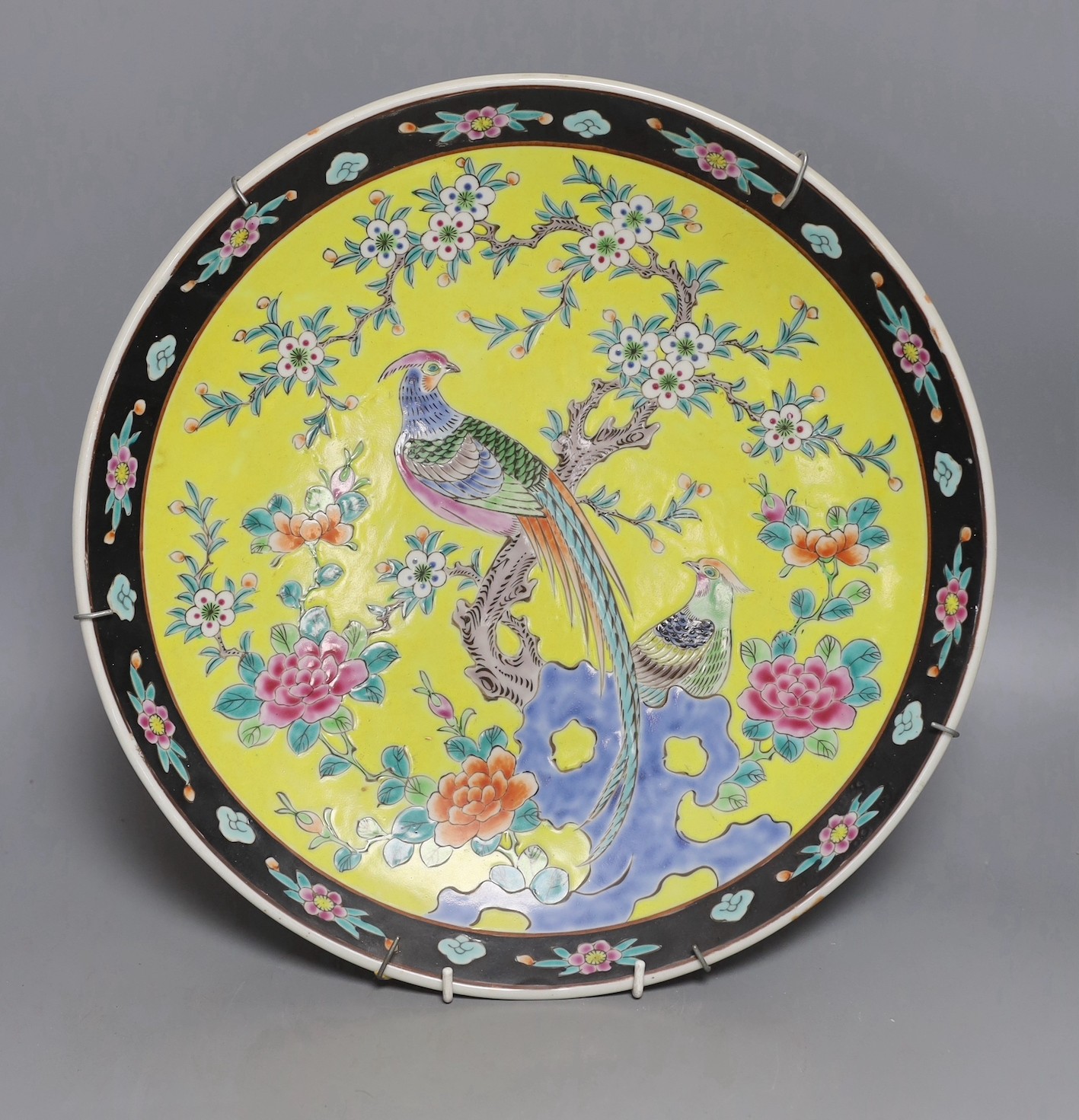 An early 20th century Japanese yellow ground dish with bird and floral decoration - 36.5cm diameter